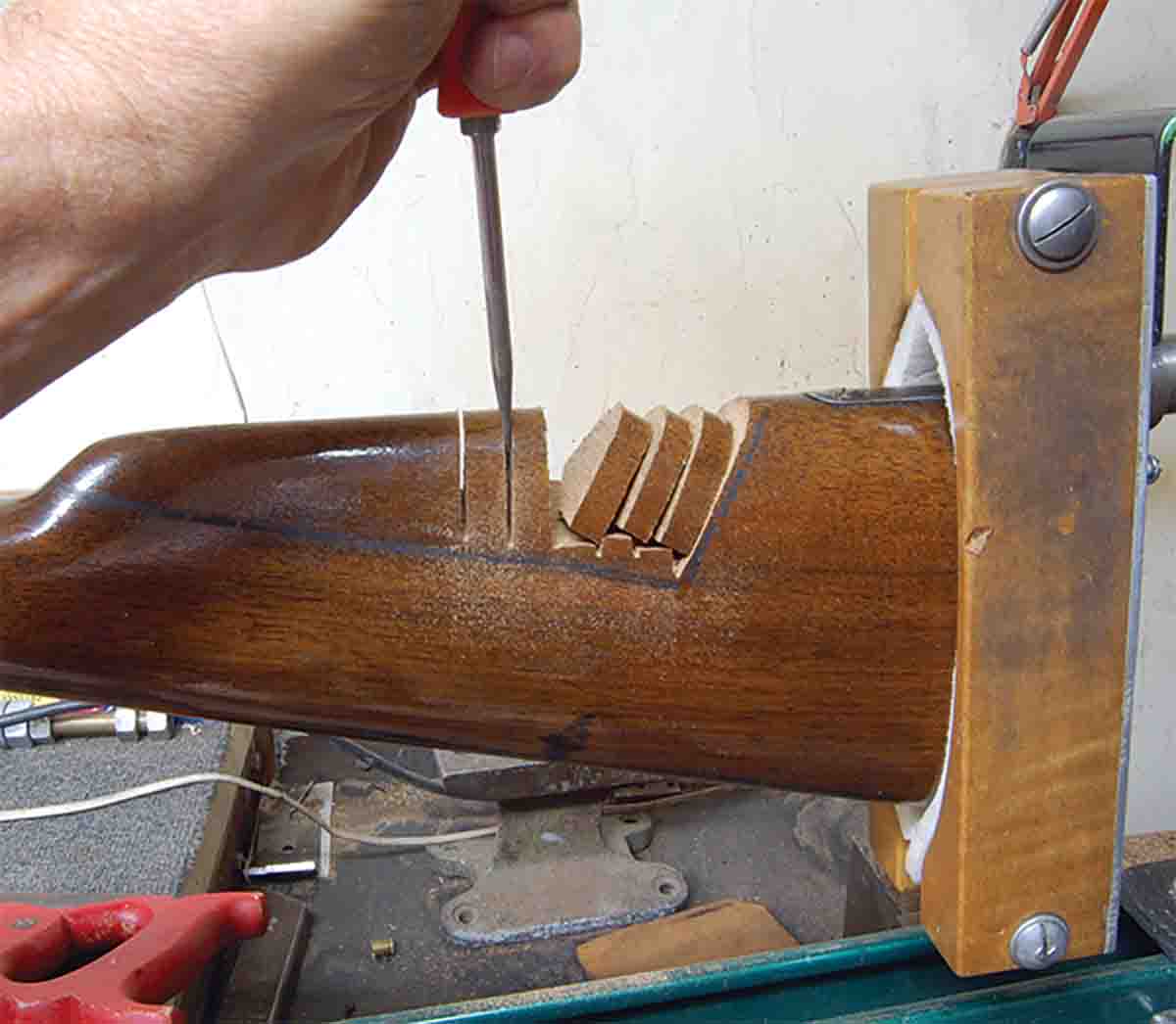 Wood is removed from the stock comb by sawing it and then snapping it off.